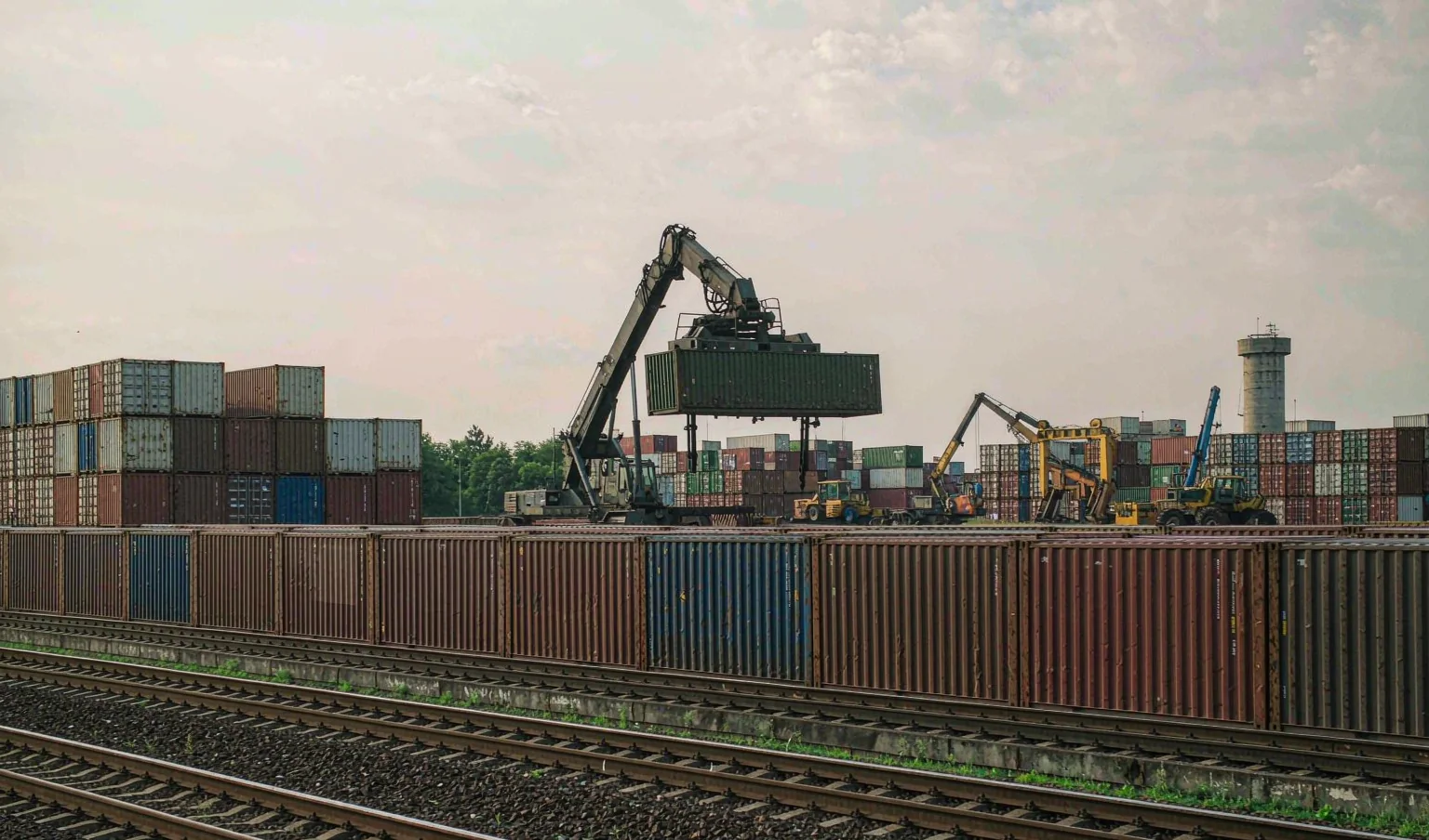 Reach stacker lifting a container at a Central Asian rail freight terminal - China to Iran rail corridor by CargoSolid
