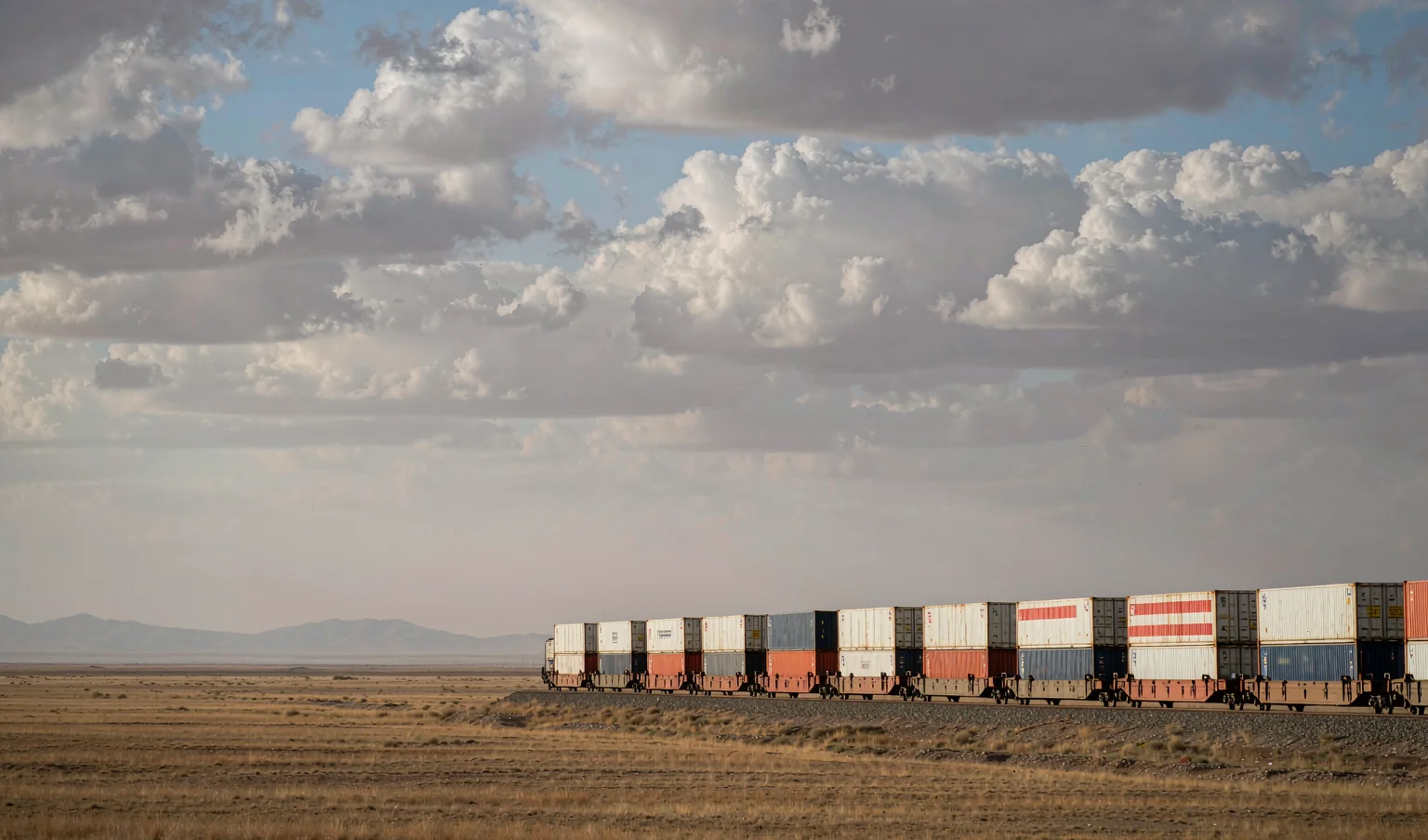 Container freight train crossing the Central Asian steppe on the China-Iran rail corridor - CargoSolid Eurasian rail freight