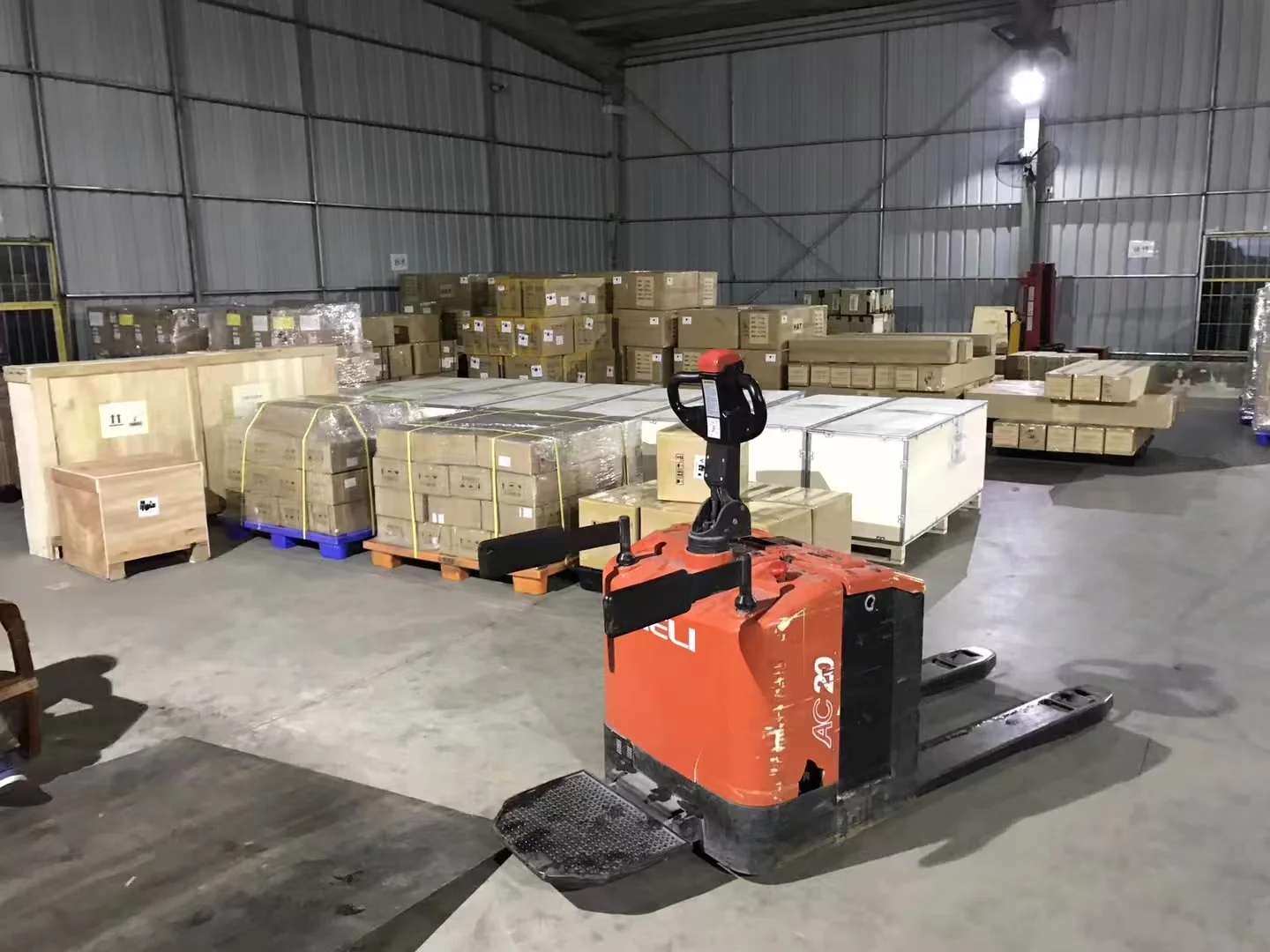 Cargo pallets and wooden cases stored in China warehouse with pallet stacker