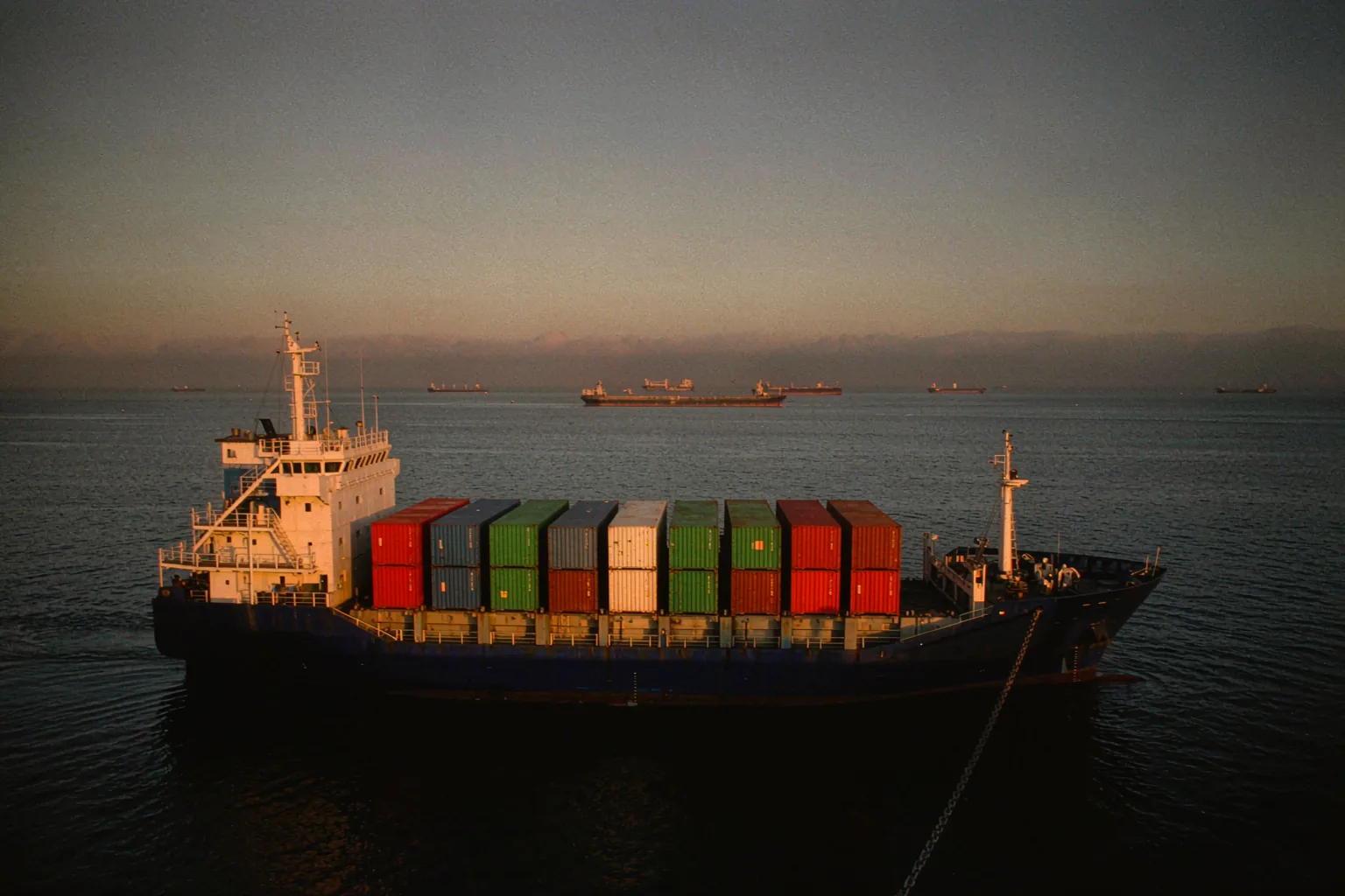 Loaded container ships waiting at anchorage near a canal entrance during the 2026 freight rate rally