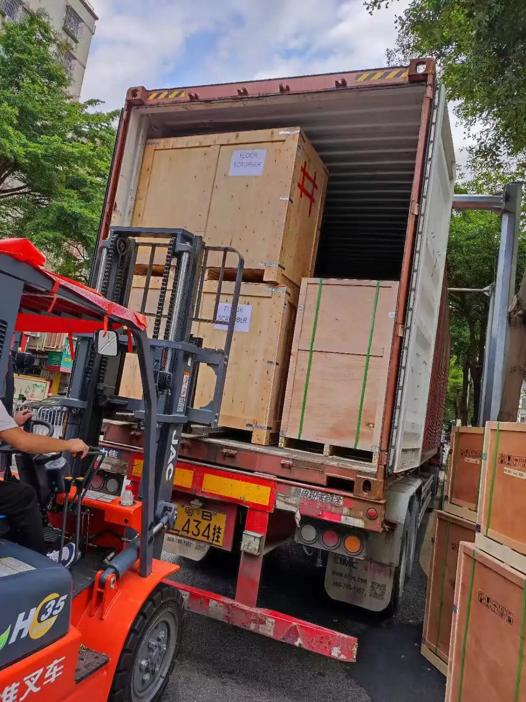 Forklift loading wooden crates into container for export from China
