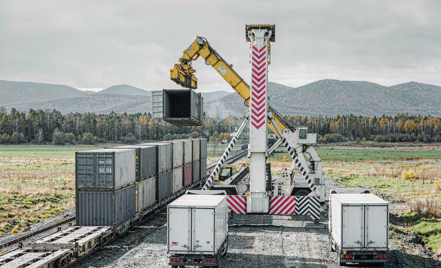 Containers being transferred between rail wagons and trucks at an inland terminal on the China to Kaliningrad route