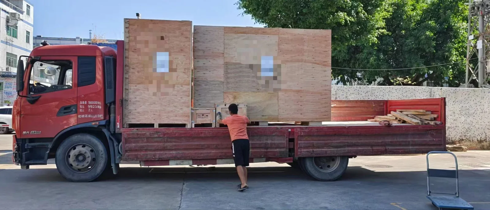 Truck being loaded with plywood crates for cross-country freight