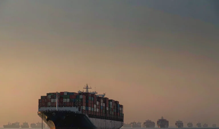 Container ships waiting at anchorage at dusk - Q4 2026 shipping risk
